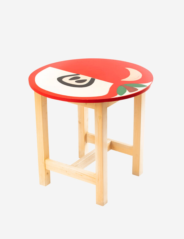 a small wooden stool with a red apple painted on it