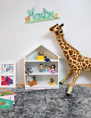 a stuffed giraffe next to a shelf
