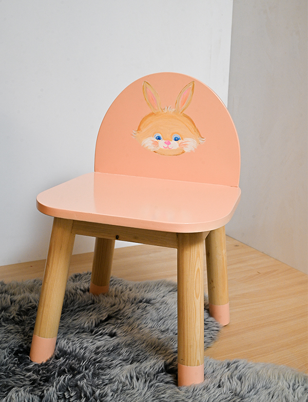 a chair painted with rabbit face on a rug