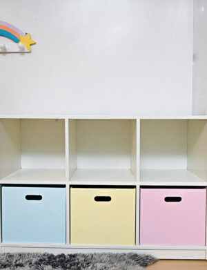 a white shelf with colorful boxes.