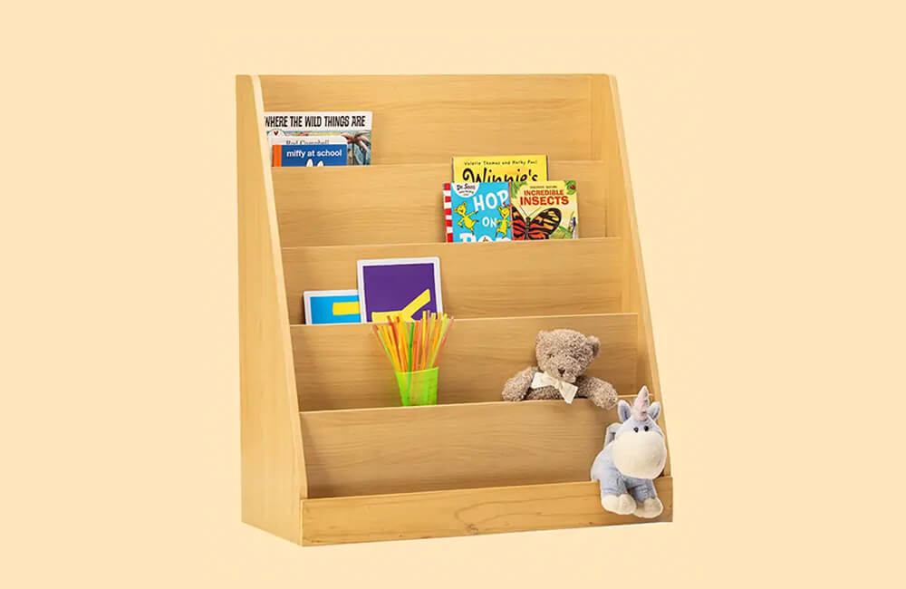 wooden book shelf carrying in it space some novels ,teddy bear and some straws.
